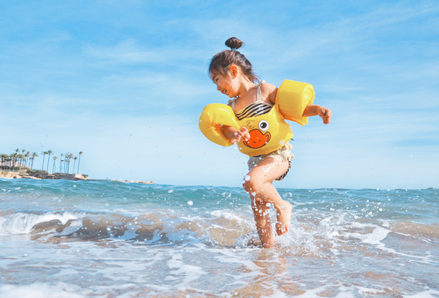 Child playing in the ocean. Photo by Leo Rivas, Unsplash.